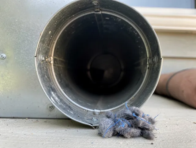 Shelton Dryer Vent Cleaning technician using specialized equipment to clear severe dryer vent blockage in Shelton